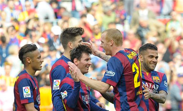 FC Barcelona's Lionel Messi from Argentina, center, reacts after scoring against Valencia during a Spanish La Liga soccer match at the Camp Nou stadium (Photo Credit: AP) FC Barcelona's Lionel Messi from Argentina, center, reacts after scoring against Valencia during a Spanish La Liga soccer match at the Camp Nou stadium (Photo Credit: AP)